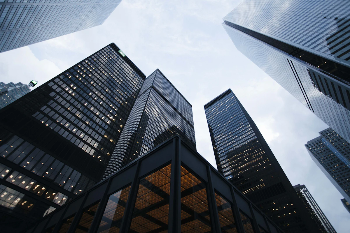 Modern glass architecture reaching towards a clear sky